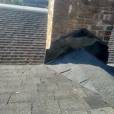 Chimney-Cricket-Installation-for-Leak-Protection-on-Shingle-Roofs 1