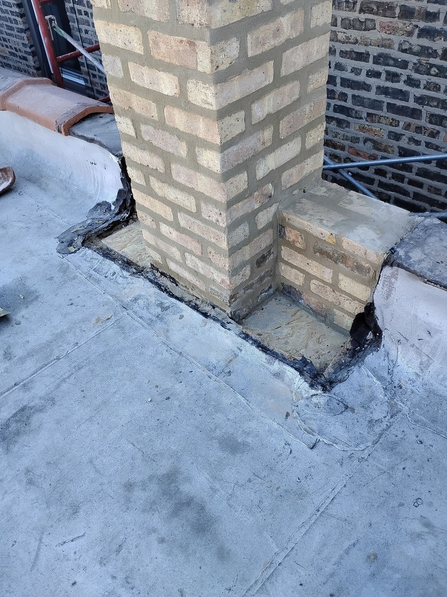 Flat Roof Leak Around Chimney in Chicago? Unsealed Membrane Could Be the Cause