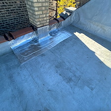 Flat-Roof-Leak-Around-Chimney-in-Chicago-Unsealed-Membrane-Could-Be-the-Cause 0