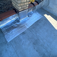 Flat-Roof-Leak-Around-Chimney-in-Chicago-Unsealed-Membrane-Could-Be-the-Cause 1